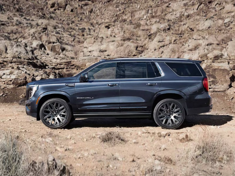 Dark SUV on rocky terrain, showcasing rugged capability and modern design.