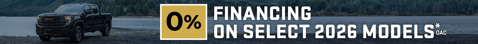 Black truck by a lake with forest background, featuring "0% financing on select 2026 models" text.